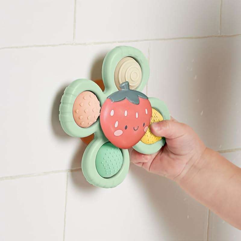 Itzy Ritzy Pop & Whirl – Fidget Spinner Travel & Bath Toy for Babies & Toddlers – Fidget w/Textured Silicone Popper to Develop Fine Motor Skills –Sticks to Highchairs, Tables, Tubs, More (Strawberry) - Image 7
